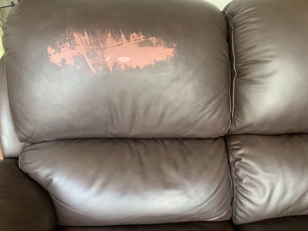 body oils damage a leather sofa (before repair by The Leather Expert)